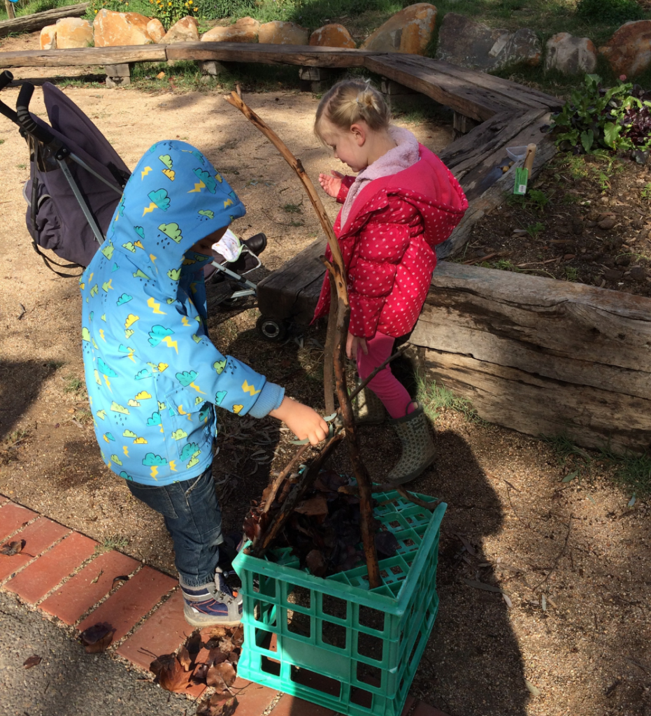 Young children stack up sticks to make a pyramid shape. Authentic learning of science concepts follows the interests of children.