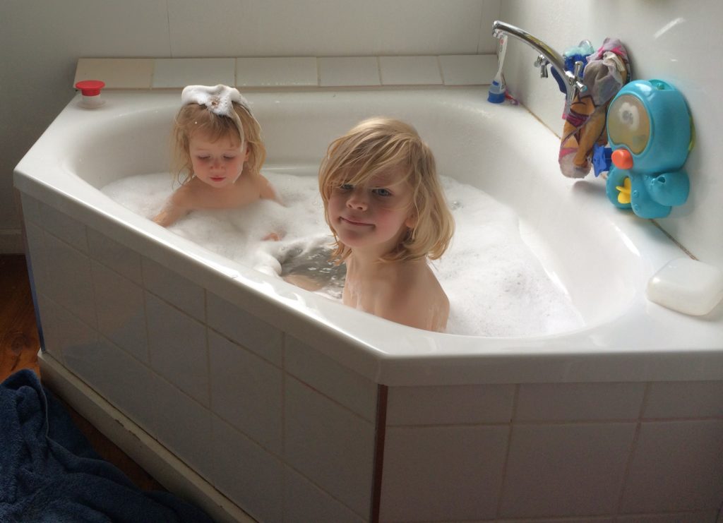 Everyday Science- two young children exploring water in a bath