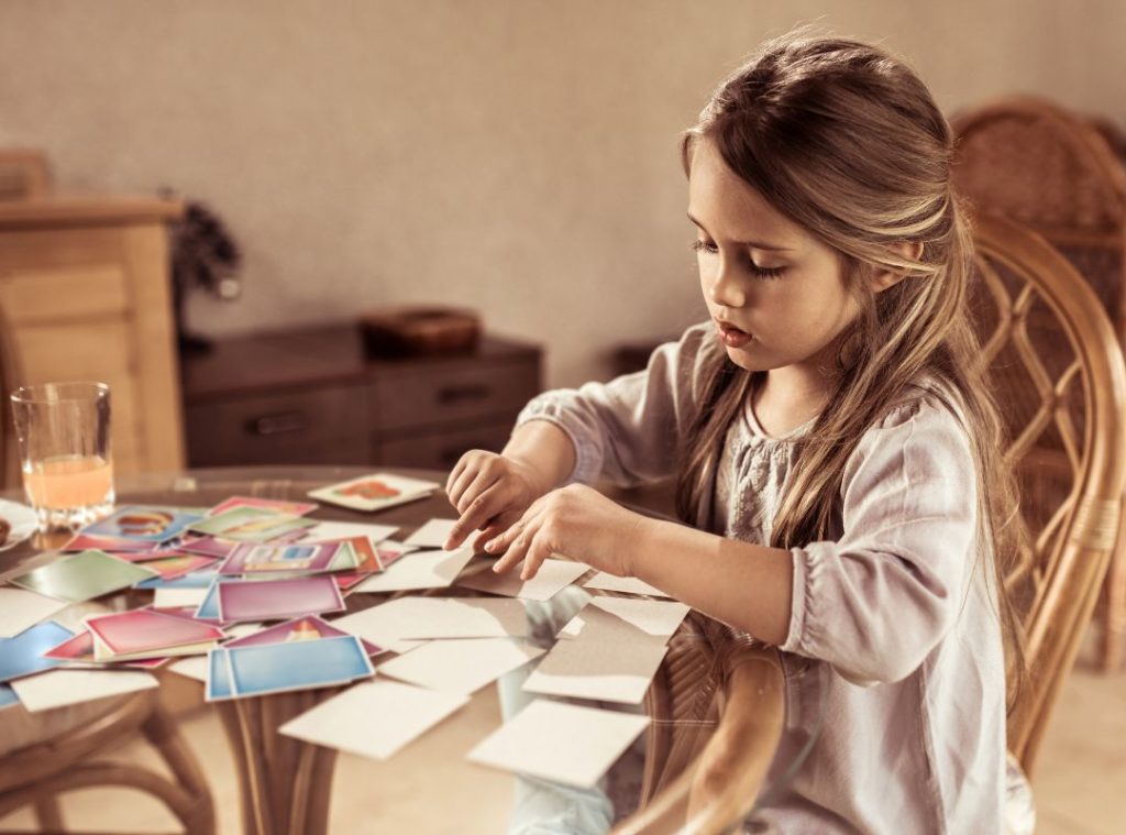 Young child playing memory. Memory can help with math development